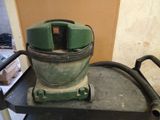 a green machine that is sitting on top of a cart