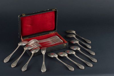 a bunch of silver spoons and forks in a case