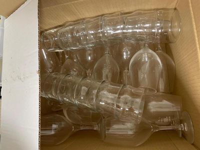 a lot of empty wine glasses in a box