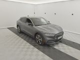 a grey 2020 ford mustang macht is parked in a garage