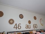 a lot of clothes hanging on the wall in a store