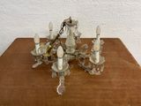 a chandelier that is sitting on a wooden table