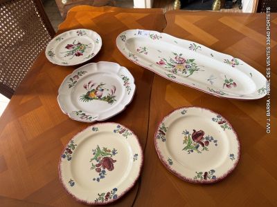 many plates and bowls on the table in the kitchen