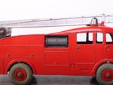 a red toy fire truck with a ladder on top of it