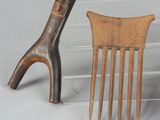 two wooden combs and a pair of scissors on a table