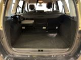 the back of a car with the trunk open and the seats down
