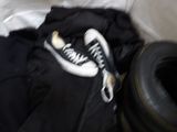 a pair of black pants and a pair of white sneakers