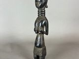 a small statue of a woman with a black head and a black dress