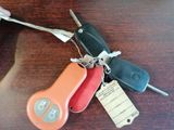 a lot of keys and a keychain on a table