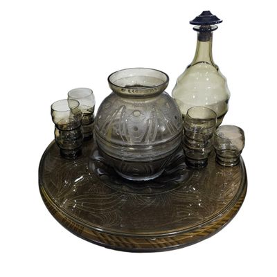 bottles and glasses are sitting on a tray on a white background