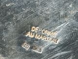 an image of a close up of a metal object with a name on it