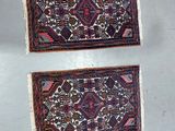 two small rugs hanging on a wall in a room