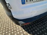 a small white car parked on the side of the road