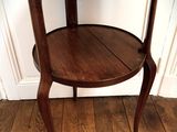 a small wooden table with a shelf on it