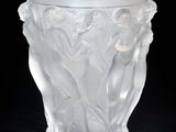 a glass vase with a design on it on a black background