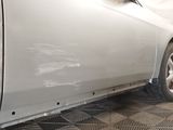a white car that has been painted white in a garage