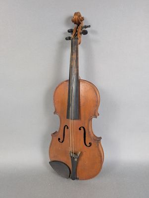 an old violin sitting on top of a table next to a wall