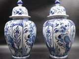 pair of blue and white vases with lids on a table