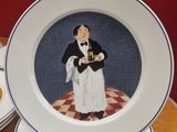 several plates with a picture of a waiter on them on a table