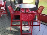 a table and chairs on the porch of a house