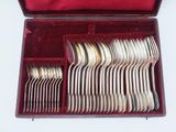 a red case with silverware in it on a white surface