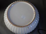 a white plate with a gold rim sitting on a table
