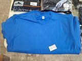 a blue shirt sitting on top of a table next to other items
