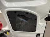 a white car with a hole in the side of it