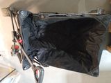 a black bag sitting on top of a black stroller