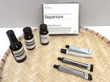 five bottles of different types of skin care products on a tray