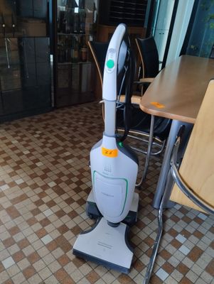 a vacuum that is sitting on the floor in the room