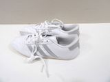 a close up of a pair of white shoes on a table