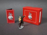 toy figurine of a man in a suit and tie with a red box
