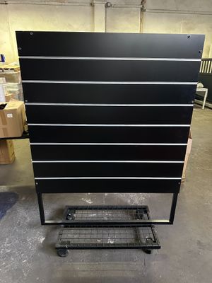 a black and white chest of drawers in a warehouse