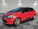 a red car is parked in a room with a checkered floor