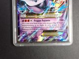 a close up of a pokemon card in a plastic container