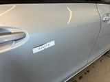 a silver car with a sticker on the side of it