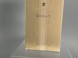 a box of perfume sitting on top of a clear table