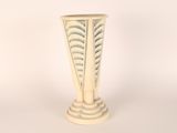 a white vase that is sitting on a table