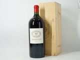 a bottle of wine sitting next to a wooden box
