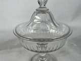 a clear glass covered dish with a domed lid