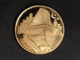 a close up of a gold coin on a black surface