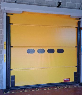 a yellow garage door with black trims in a building