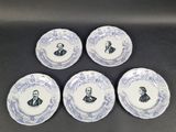 four blue and white plates with a picture of a man and a woman on them