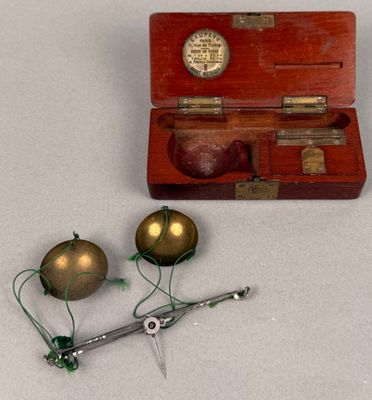 a small wooden box with two ornaments and a pair of scissors