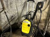a yellow and black power washer sitting on a wooden pallet
