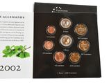 booklet with a picture of a bunch of coins and a card with a picture of a plant on it