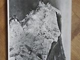 black and white photograph of a snow covered mountain on a wooden table