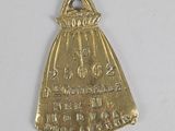 an old brass bell with a bell on top of it on a white surface