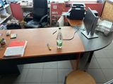 a desk with a chair and a computer on it